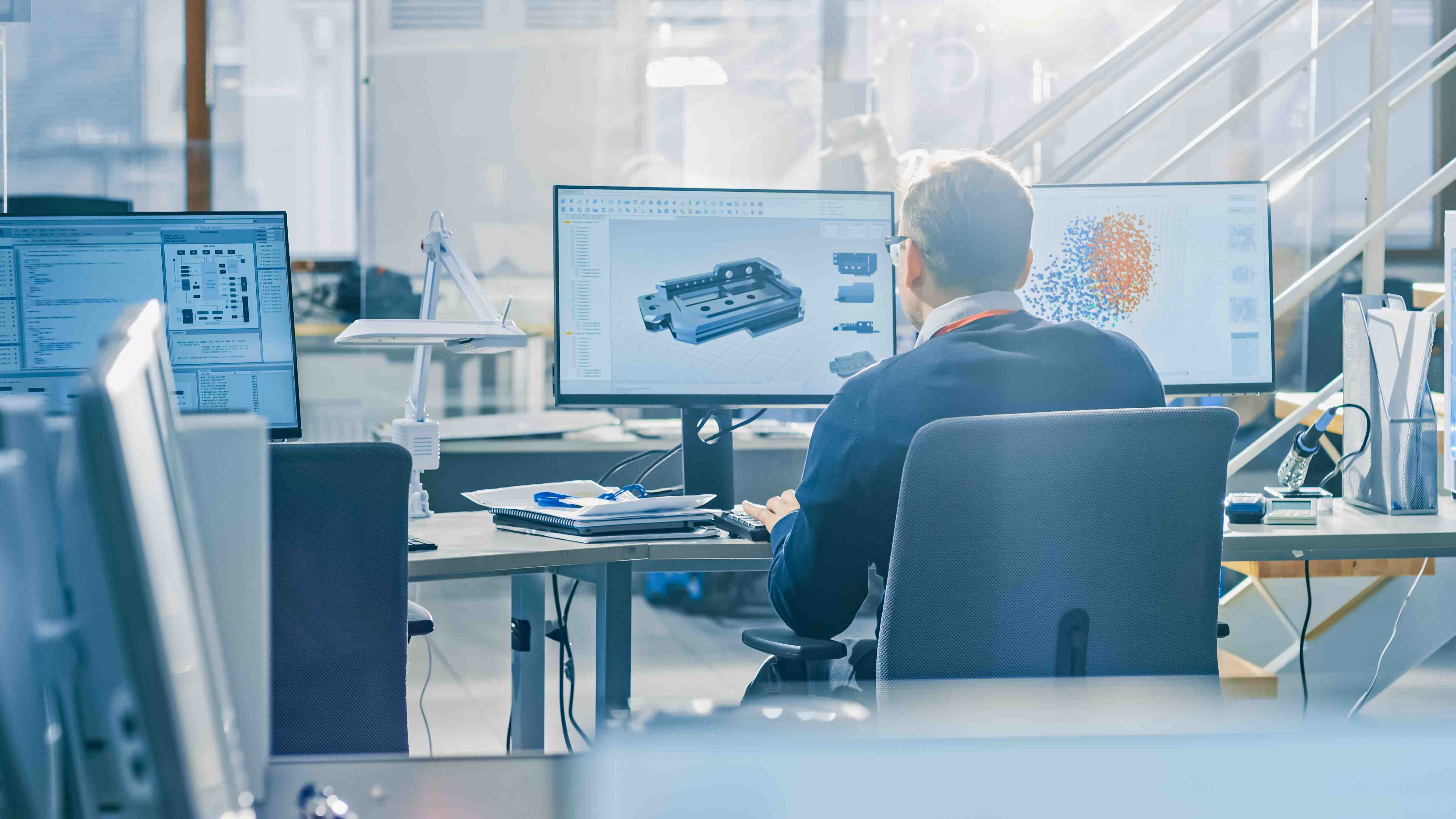 Back View of Industrial Engineer Working on Desktop Computer in